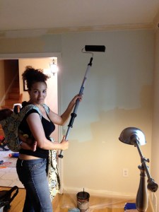 Mom painting with baby on back